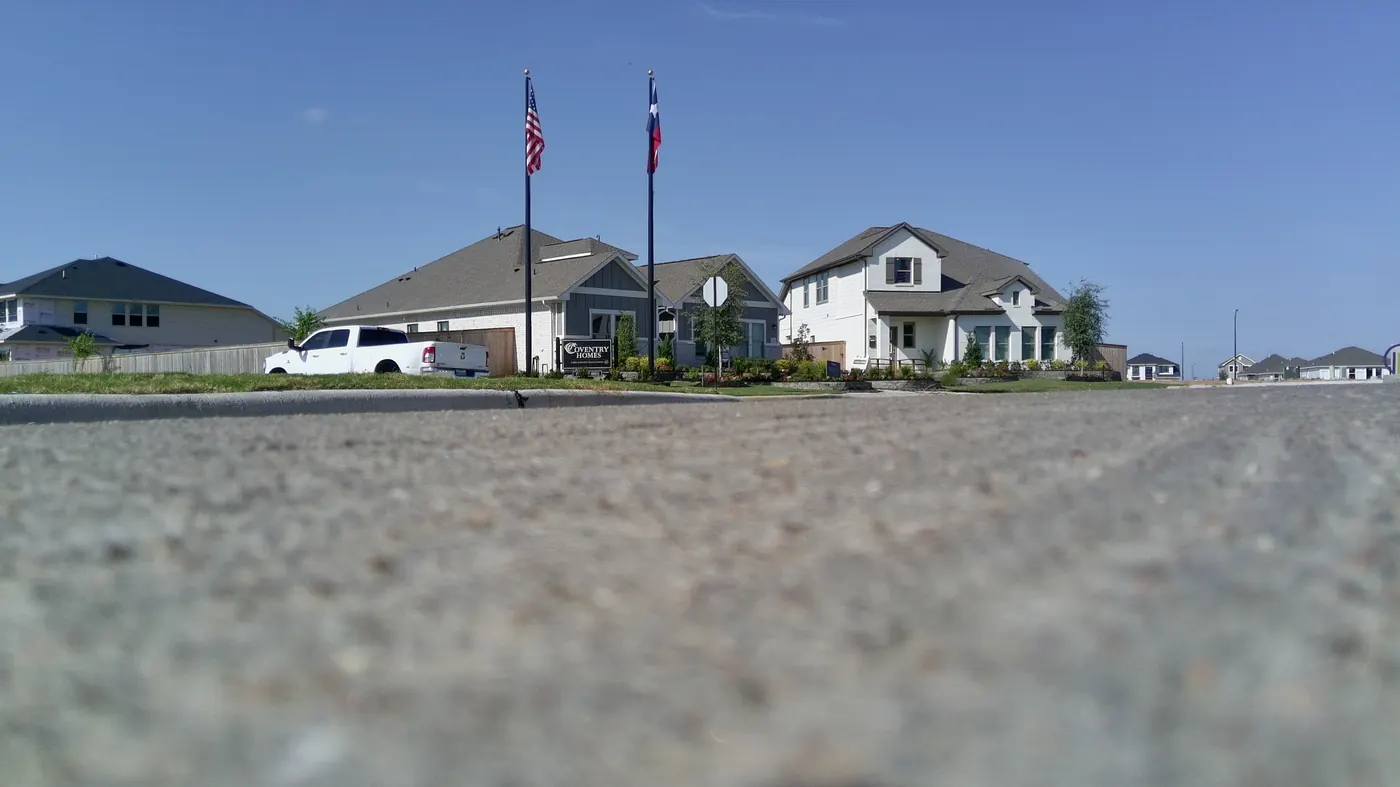 Coventry Homes model homes with flags at Sofi Lakes in Katy, TX